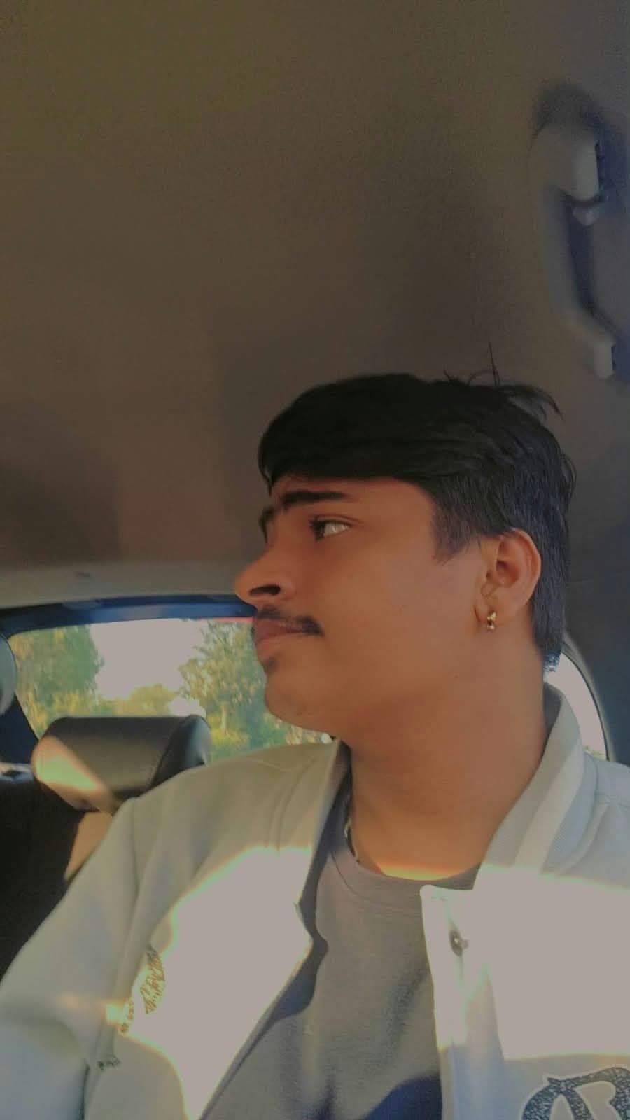 Shubh in a car, looking out of the window